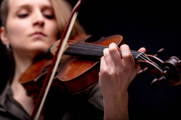 istock hand closeup of a violinist on black 822173466