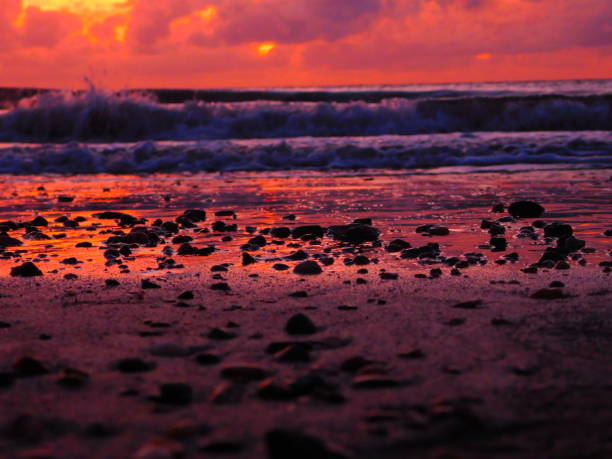 shimmering rocks against the ocean tide at sunrise