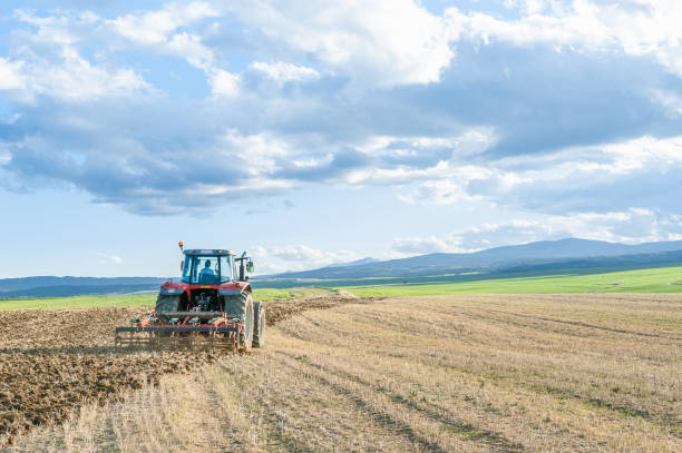 istock tractor in the lands along with gear for work 822189918