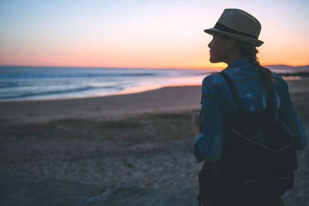 istock Young woman with backpack on the beach 822193138