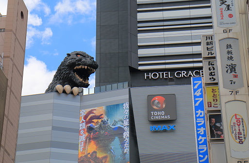 Tokyo Japan - July 11, 2017: Godzilla statue at Toho cinemas Shinjuku in Tokyo Japan. TOHO Cinemas is a Japanese film, theatre production and distribution company and famous for Godzilla movies.