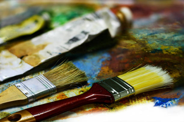 istock New brush, art tools on the old palette 822249798