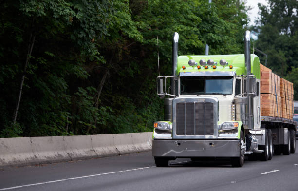 istock Customized classic big rig semi truck with flat bed trailer transporting lumber wood 822250610