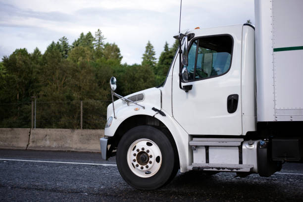 istock Medium power class semi truck with box trailer on the road 822253104