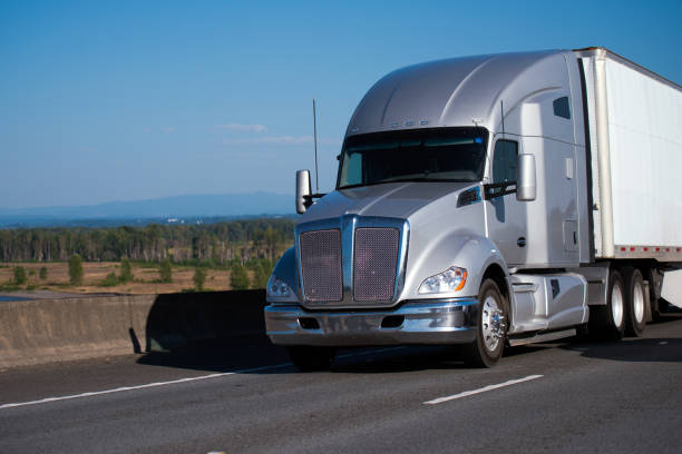istock Silver modern big rig semi truck with trailer running on freeway 822253588