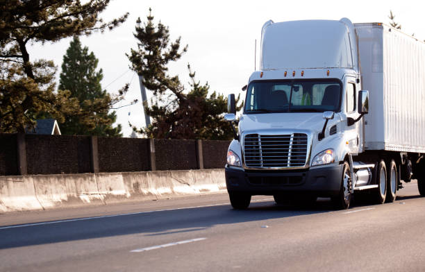 istock White modern semi truck with container for cargo carriers on the road 822254036