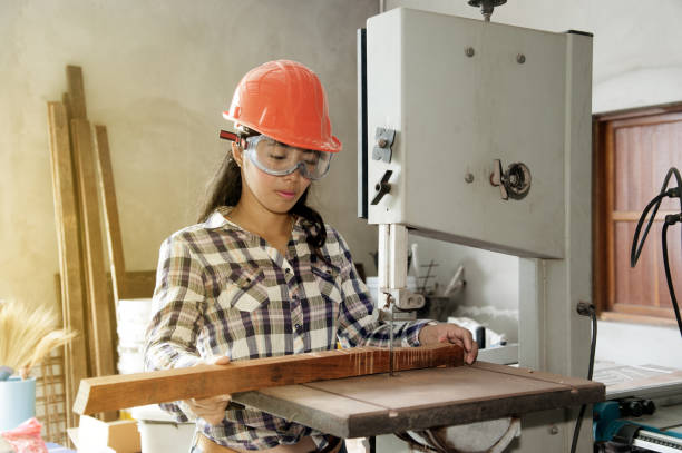 istock Asian pretty female carpenter Using Electric Sander for wood. 822256966