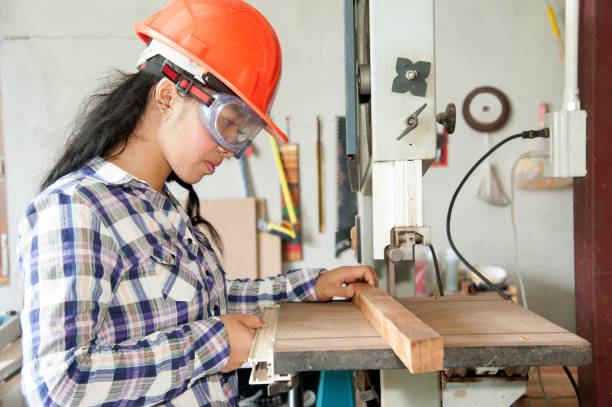 istock Asian pretty female carpenter Using Electric Sander for wood. 822257002