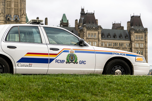 RCMP car in front of the Canada Parliament, Ottawa. This image shows a Royal Canadian Mounted Police vehicle on display.