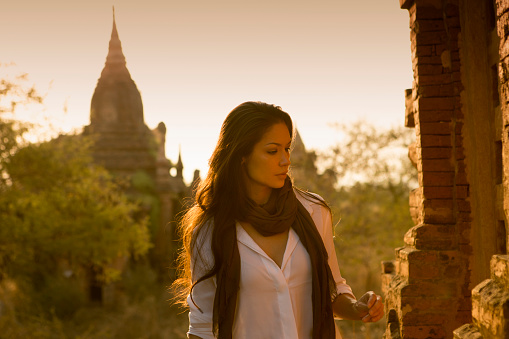 Beautiful woman exploring the ancient temple sites of Bagan in Myanmar.