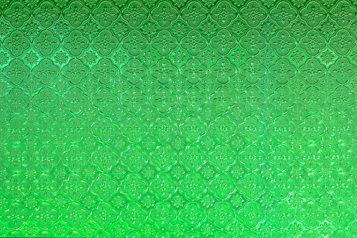 vintage stained glass window of green colored glass.