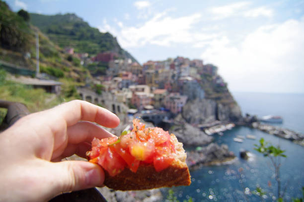 bruschetta in hand - italian appetizer imagens e fotografias de stock