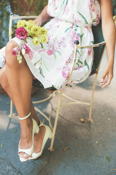 istock Woman holding flower in her lap 822302100