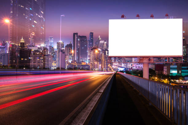 istock Blank billboard near light trails on street in the night 822302864