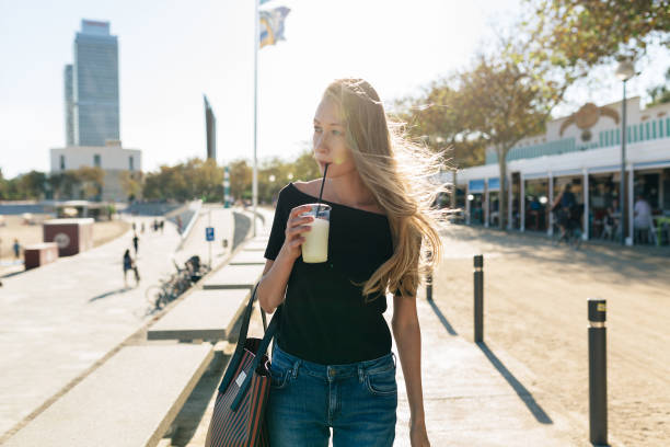 istock Beautiful woman having a fresh drink outdoors in summer 822310686