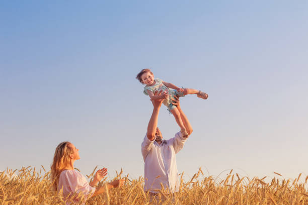 istock happy family in cereal field at sunset 822310880