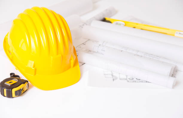 istock Yellow safety helmet and plan drawing 822318082