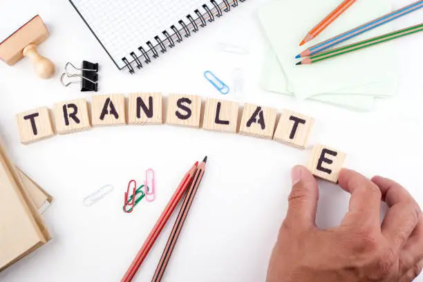 Photo of Translate concept. Wooden letters on a white background