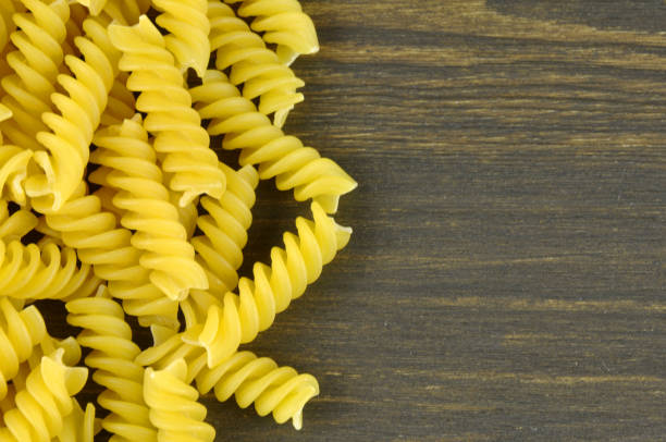istock Fusilli pasta on dark wood background 822326570