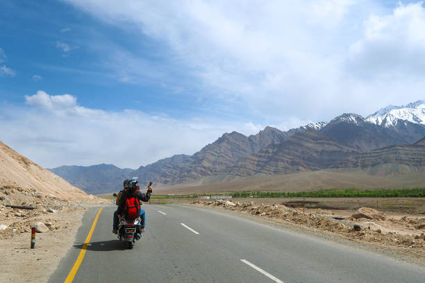 tourist riding motorbike on the road Leh Ladakh - India stock photo