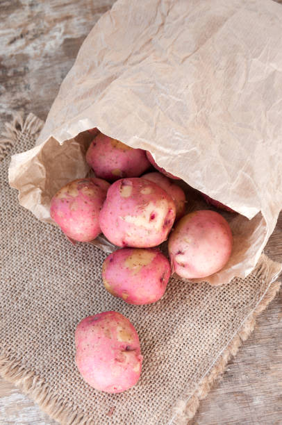 istock Red potatoes in a paper bag on table 822337654