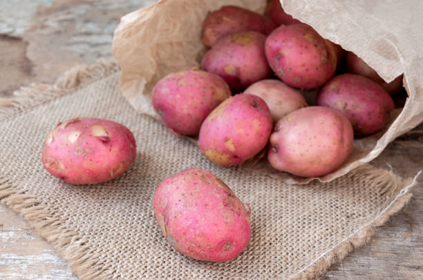 istock Red potatoes in a paper bag on table 822338468