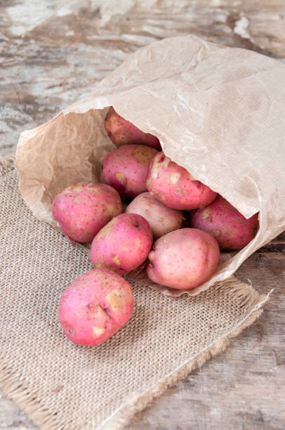 istock Red potatoes in a paper bag on table 822345308