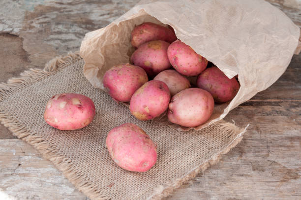 istock Red potatoes in a paper bag on table 822348268
