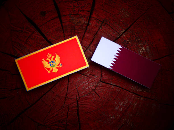 istock Montenegrin flag with Qatari flag on a tree stump isolated 822348510