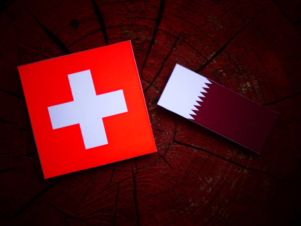 istock Swiss flag with Qatari flag on a tree stump isolated 822348602