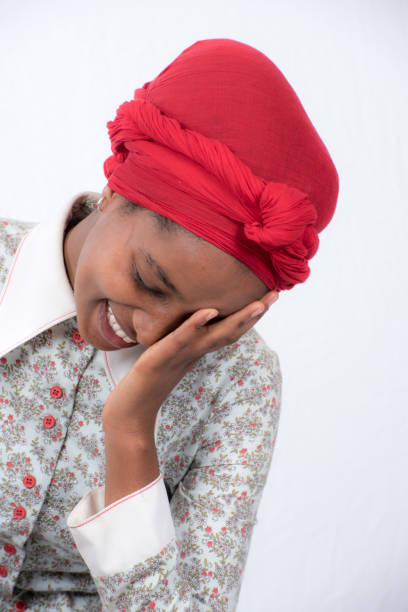 istock Ethiopian girl laughs and holds head in hands. 822353468