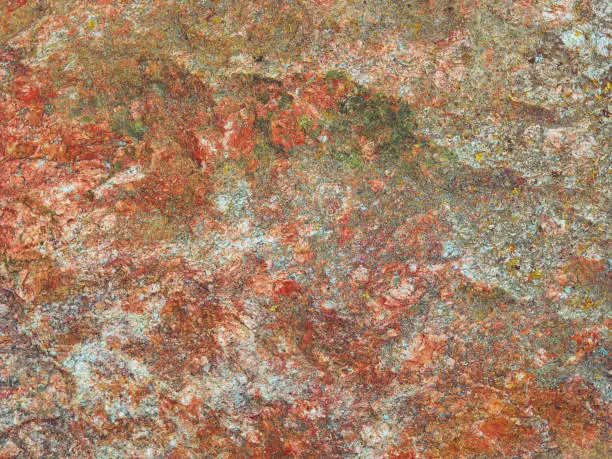 Colorful red green cyan and white stone rock texture for background