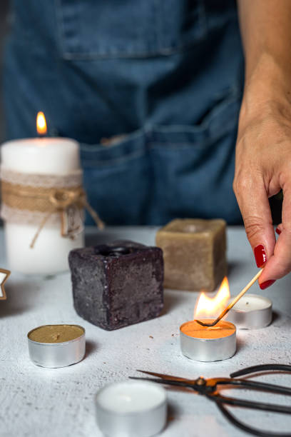 istock Unrecognizable woman hands lighting candles 822358752