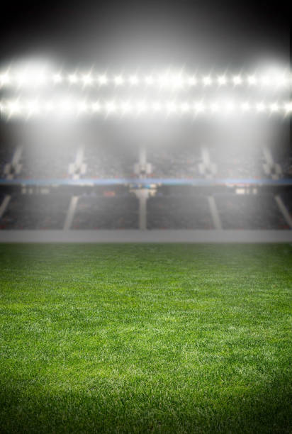 spotlights at the soccer arena green soccer field empty with row of bright spotlights illuminating the stadium in night lancashire photos stock pictures, royalty-free photos & images