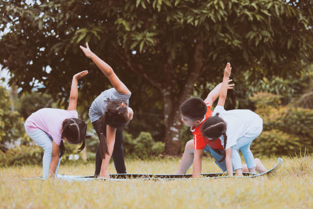 istock Happy children doing exercise together in outdoor in summer time 822365220