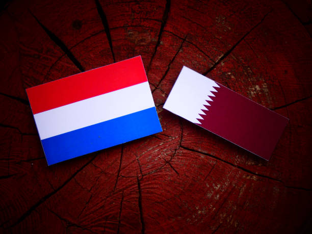 istock Dutch flag with Qatari flag on a tree stump isolated 822367296