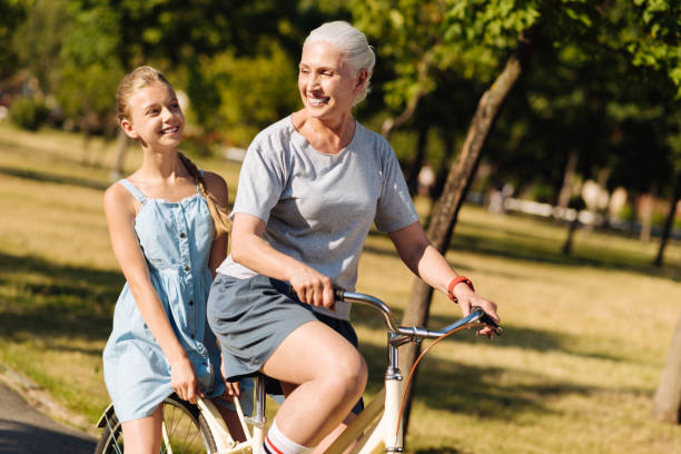 istock Delighted positive senior woman riding a bicycle 822369576