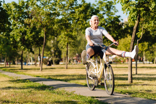 istock Joyful senior woman riding a bicycle 822369684