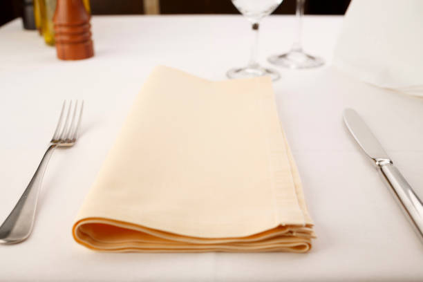 istock Fork and table knife with napkin arranged in elegant setting, Wineglass in the background, Selective focus with soft light 822376646