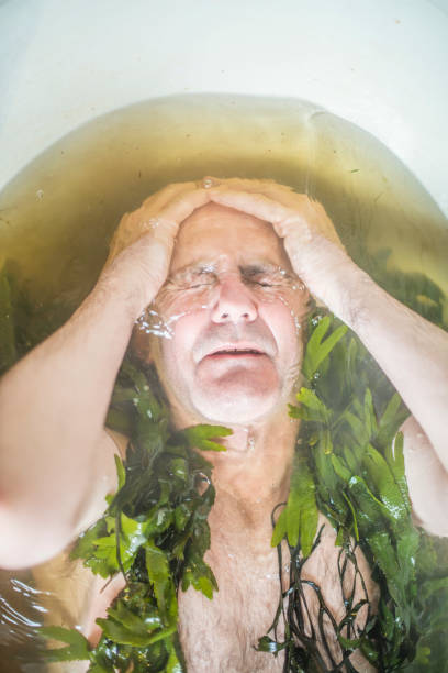 istock Senior man in seaweed bath 822381040