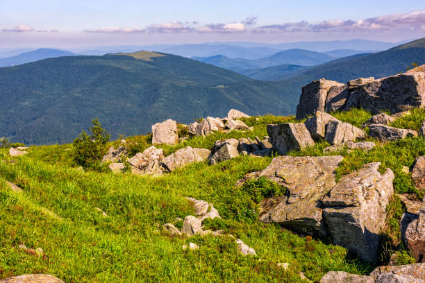 huge boulders on the edge of hillside. fine weather in summer mountain landscape