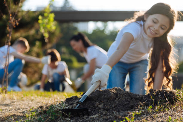 istock Careful longhaired brunette standing on knees while gardening 822397982