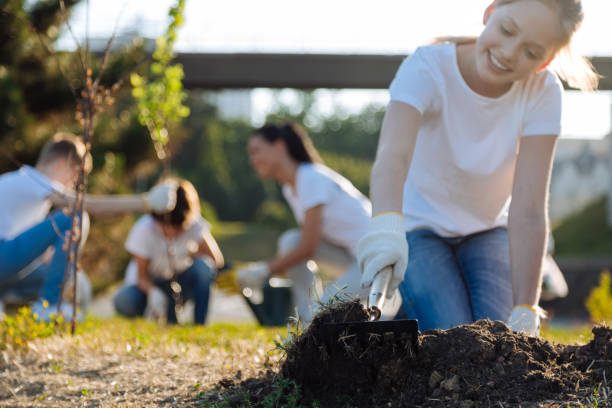 istock Smiling girl raking up soil for plants 822398182