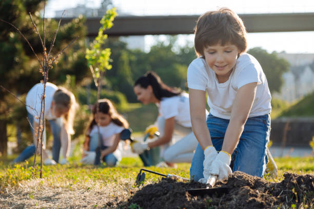 istock Kind man-child raking ground with pleasure 822399198