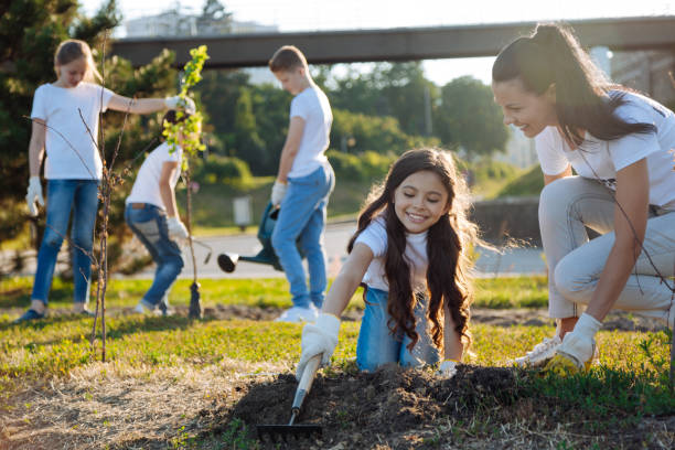 istock Joyful kids watering new tree 822399484