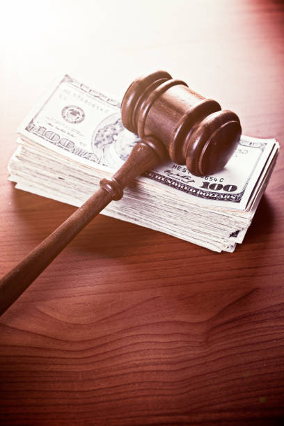 istock Many American $100 banknotes stacked, with judge's gavel 822402594