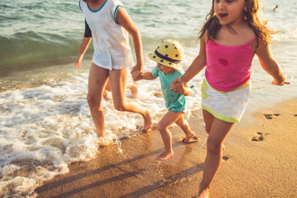 istock Children running on the beach 822402950