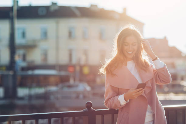 istock Young woman with smart phone at sunlight 822418696