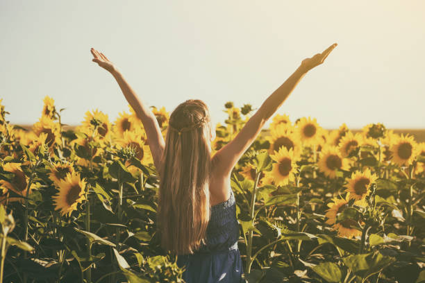 istock Woman enjoys in sunflower field 822448746