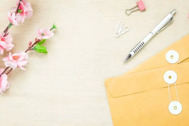 Top view business office desk background.The stationery desktop the ballpen letter flower clip on wooden table background with copy space.flat lay.above.